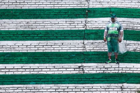 A solitary fan pays his lone tribute against the backdrop of the club's green and white colors.  