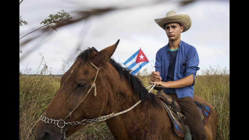 A man on horseback Saturday, December 3, waits on the side of the road for the caravan carrying the ashes of former Cuban President Fidel Castro, who died at age 90 on November 25. 