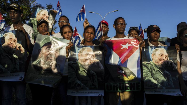 Cuban government supporters chant for Fidel Castro near the entrance of the cemetery on December 4. 