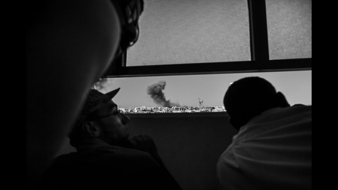 Libyan forces watch an airstrike on ISIS positions in September.