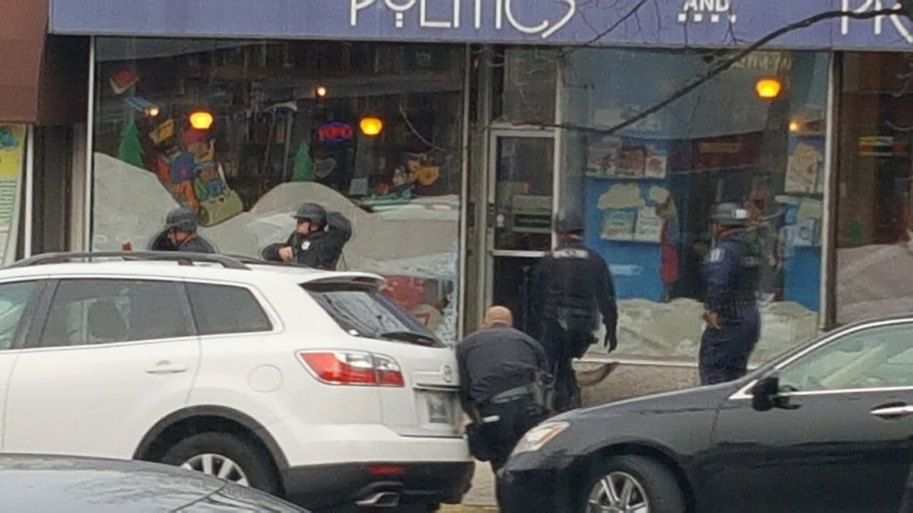 DC police respond to the pizzeria after a man with a gun entered the premesis. 