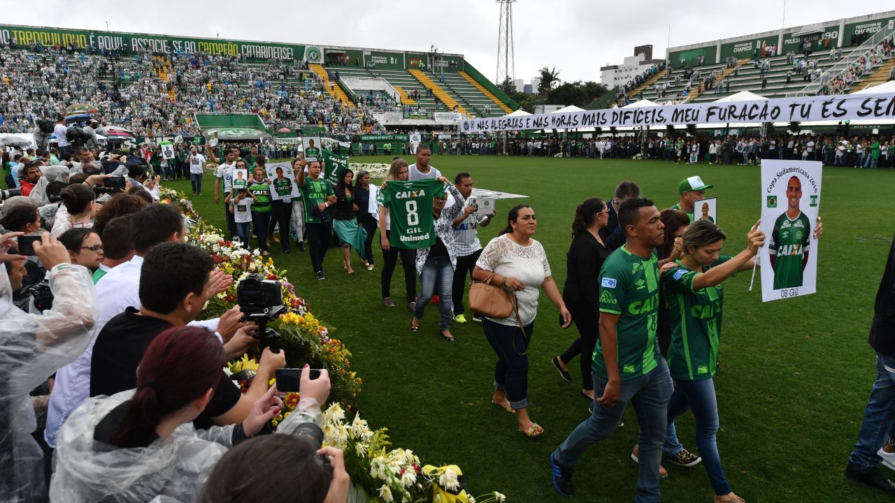 Fans and relatives pay their respects to the victims of the plane crash at a funeral ceremony held in Chapecoense's stadium.