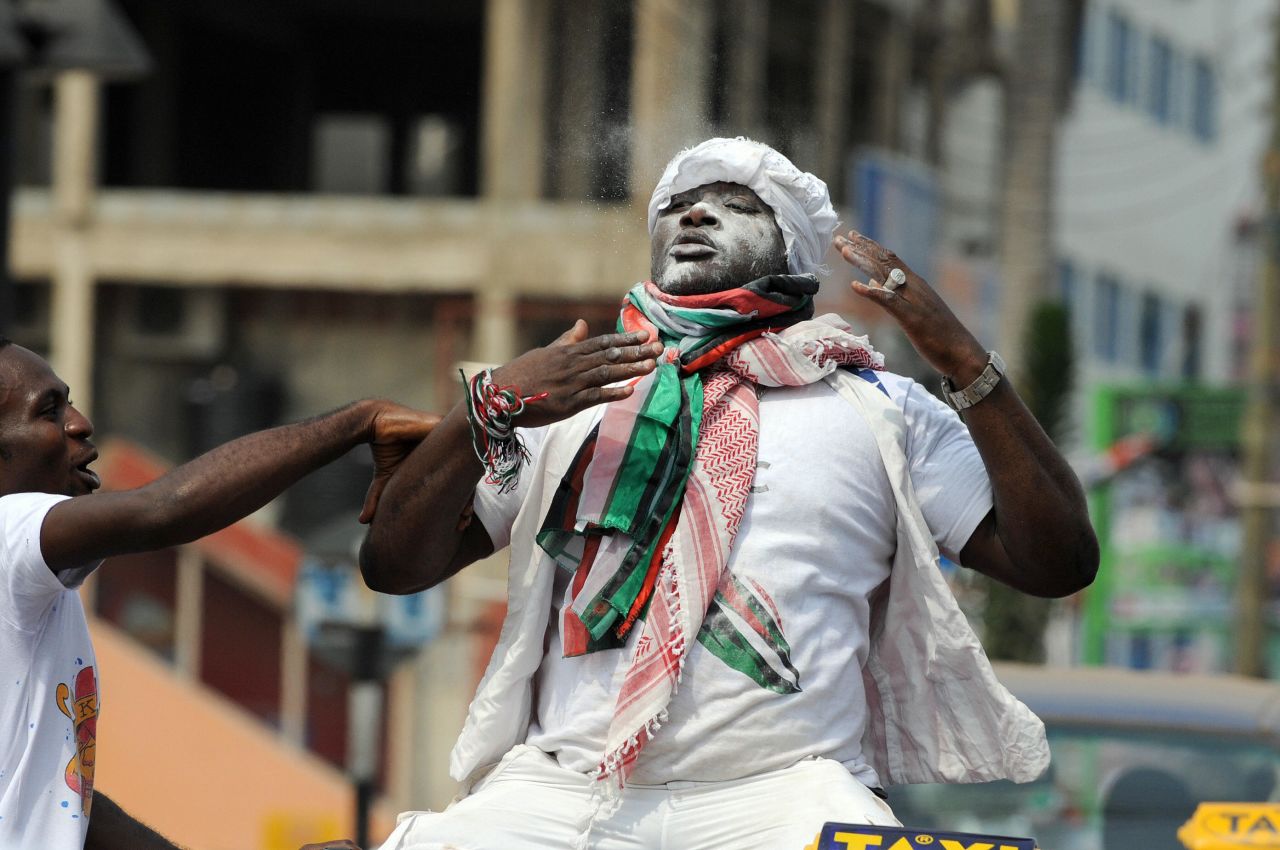 A Supporter of National Democratic Congress (NDC) celebrates sitting on a taxi shortly after John Atta Mills is declared winner of the run off presidential election in Accra Saturday, on January 3, 2009.