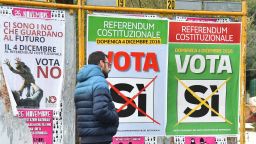 A man walks past campaign posters to vote for a referendum on constitutional reforms, on December 2, 2016 in Rome. Italy holds a referendum on December 4, 2016 on proposed constitutional reforms that are considered the most important in the eurozone country since World War II.  / AFP / Filippo MONTEFORTE        (Photo credit should read FILIPPO MONTEFORTE/AFP/Getty Images)