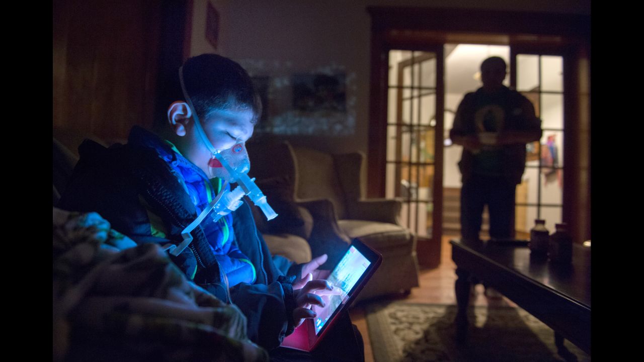 Daniel Iniguez uses a nebulizer every morning to inhale medicine in his home in Ontario, California.
