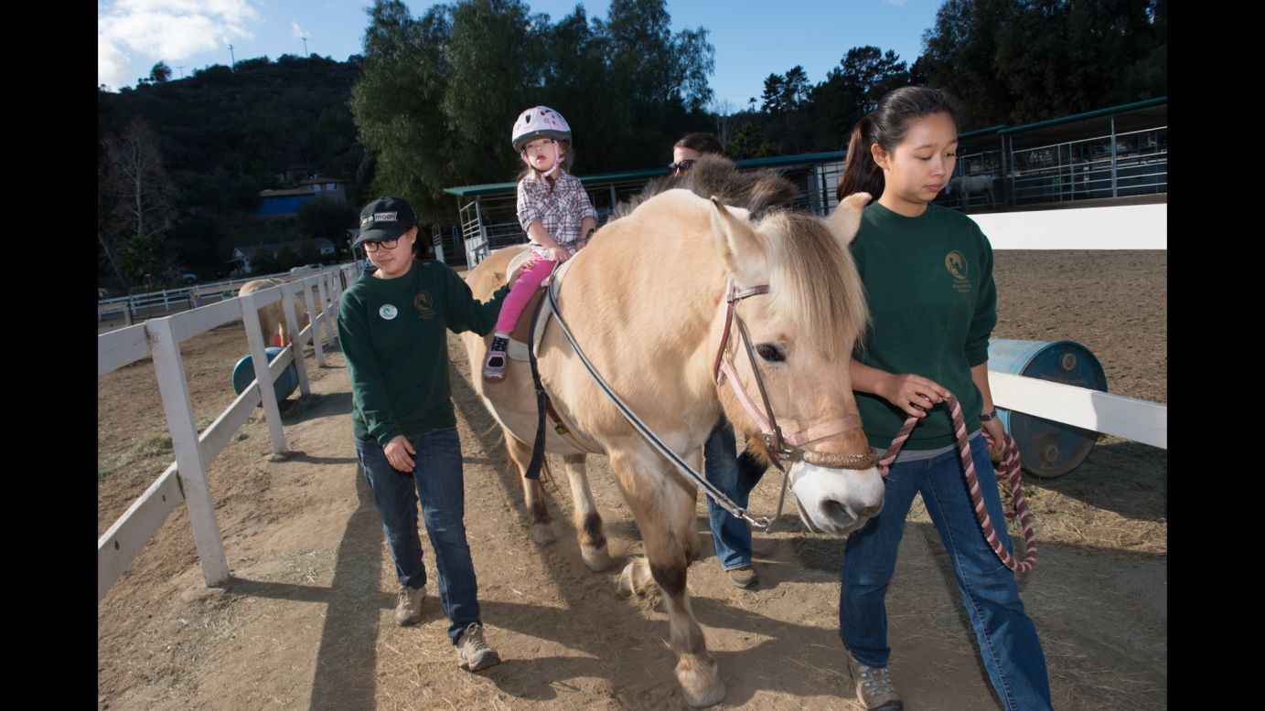Isabella rides her favorite horse, Mary, at Reins Therapeutic Horsemanship Program in Fallbrook, California. Horse therapy has helped Isabella strengthen her muscles.