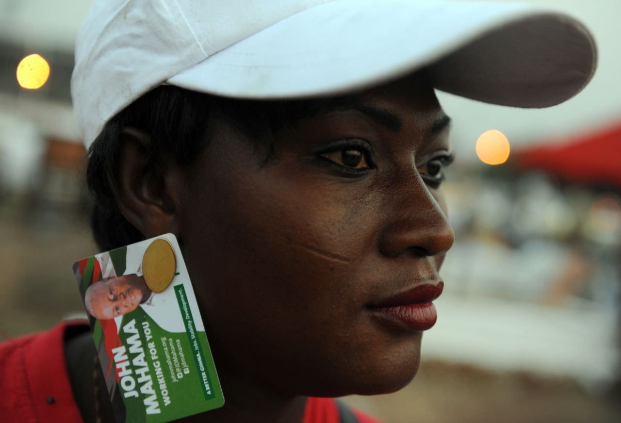 A party supporter wears earings designed in the names of Ghanaian President John Dramani Mahama