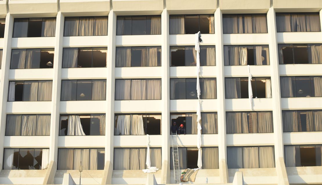 Pakistani fire fighters look from a room of Regent Plaza Hotel following a fire in the Pakistan's port city of Karachi on December 5.