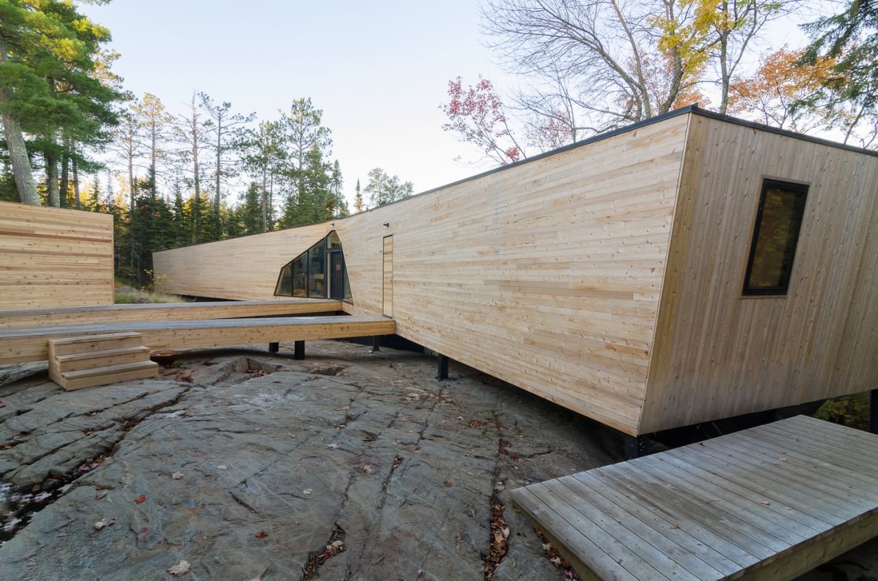 Also by Lazor, this house got its name as the two prefabricated modules kiss on the corner when installed. The open break forms a V-shaped outdoor room facing the water.