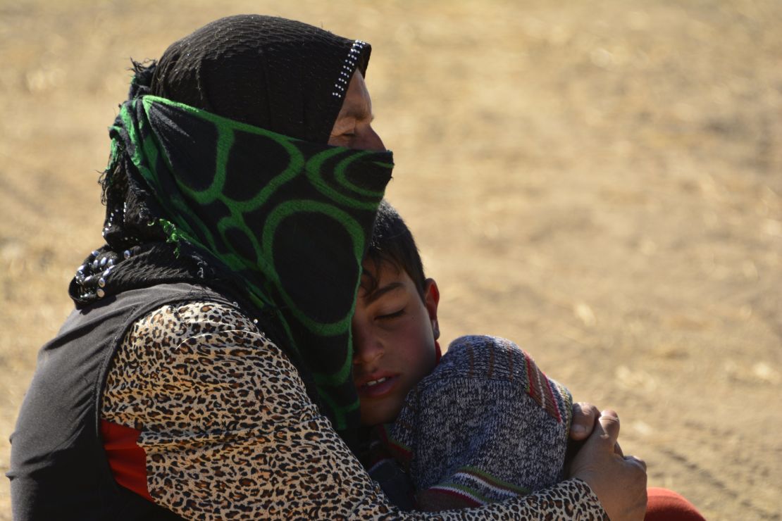 Um Ali fled the village of Kirfrouk. She and her children are now sleeping in the desert.