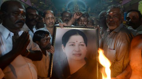 Supporters hold a photograph of Tamil Nadu state leader Jayalalithaa Jayaram as they offer prayers in Mumbai on December 5, 2016. 