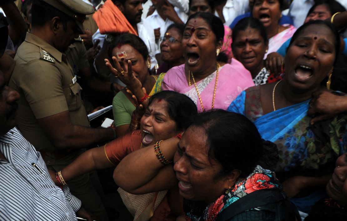 Indian supporters of the Chief Minister of Tamil Nadu Jayalalithaa Jayaram react outside the hospital where she was being treated in Chennai on December 5, 2016.