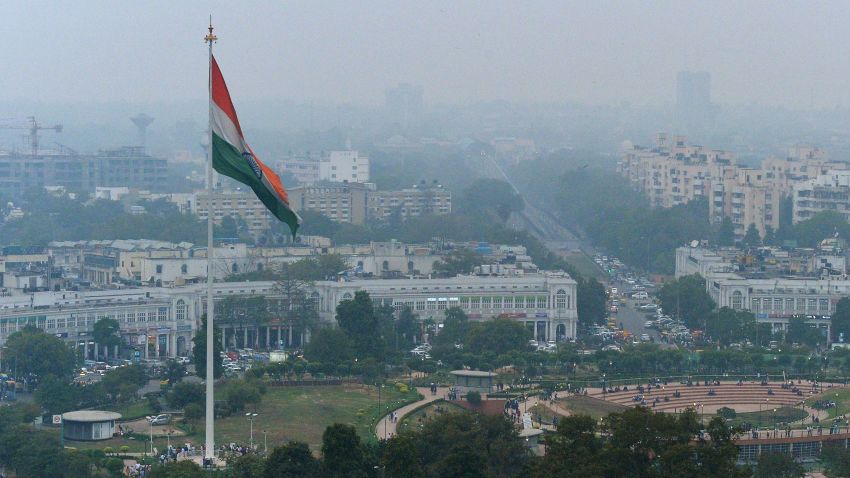 In this photograph taken on February 24, 2015, shows the Indian tri-colour as it flies over Connaught Place in New Delhi, ahead of World Environment Day which falls on June 5. The Indian government is under intense pressure to act after the World Health Organization last year declared New Delhi the world's most polluted capital. At least 3,000 people die prematurely every year in the city because of air pollution, according to a joint study by Boston-based Health Effects Institute and Delhi's Energy Resources Institute. AFP PHOTO / CHANDAN KHANNA (Photo credit should read Chandan Khanna/AFP/Getty Images)