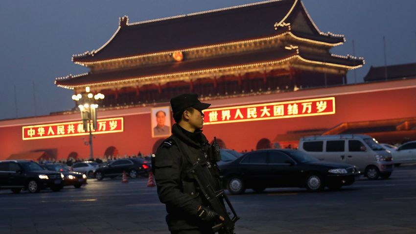 BEIJING, CHINA - NOVEMBER 08:  An anti-terror police officer patrols with the gun at Tiananmen Square on November 8, 2013 in Beijing, China. The Communist Party of China (CPC) will convene the Third Plenary Session of the 18th CPC Central Committee from November 9 to 12 to discuss comprehensively deepening reforms.  (Photo by Feng Li/Getty Images)
