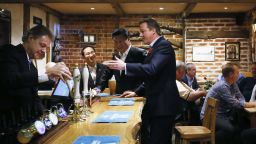 PRINCES RISBOROUGH, ENGLAND - OCTOBER 22: China's President Xi Jinping and Britain's Prime Minister David Cameron drink a pint of beer during a visit to the The Plough pub on October 22, 2015 in Princes Risborough, England. The President of the People's Republic of China, Mr Xi Jinping and his wife, Madame Peng Liyuan, are paying a State Visit to the United Kingdom as guests of The Queen.  They will stay at Buckingham Palace and undertake engagements in London and Manchester. The last state visit paid by a Chinese President to the UK was Hu Jintao in 2005.  (Photo by Kirsty Wigglesworth - WPA Pool/Getty Images)
