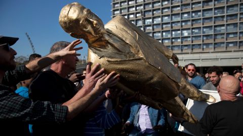 People carry a statue of Israeli Prime Minister Benjamin Netanyahu after it was placed without permit at Rabin Square in Tel Aviv.