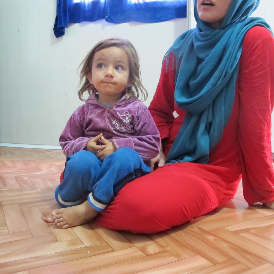Isra Aksram and one of her three children; the family fled Bartella when ISIS overran their hometown.