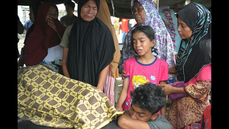 A family reacts to the death of a relative who was killed in the earthquake.