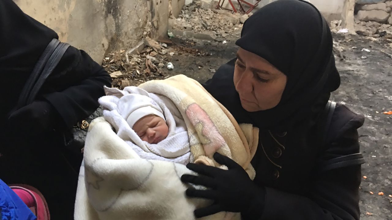 Residents, including this 7-day-old baby, flee eastern Aleppo after the Syrian army's gains.
