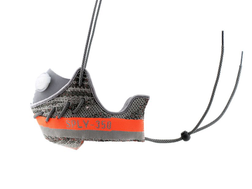 The Yeezy mask was crafted from two halves of the shoes' orange and gray primeknit uppers. The sneaker's signature "SPLY 350" branding is visible on either side.