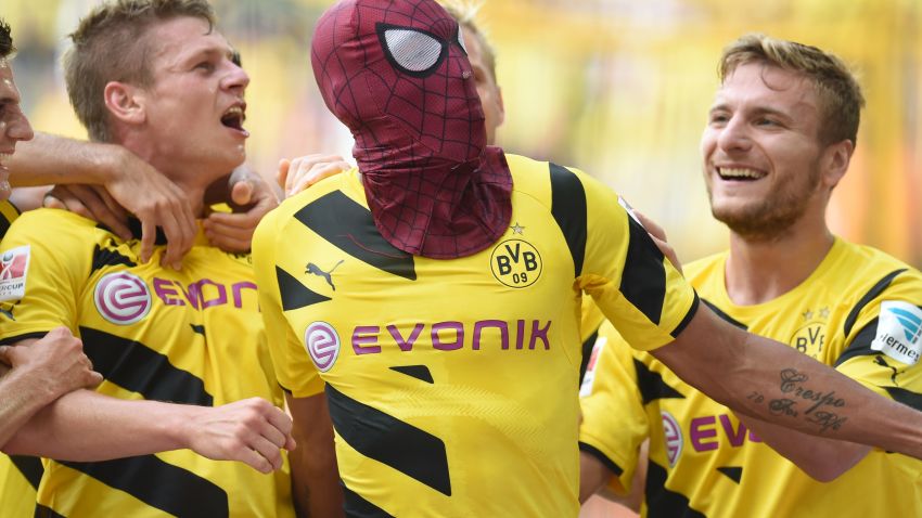 Dortmund's Italian striker Circo Immobile (R), Dortmund's Polish defender Lukasz Piszczek (L) celebrate after Dortmund's Gabonese striker Pierre-Emerick Aubameyang, who put on a Spiderman mask, scored the 2-0 goal during the German Supercup football match Borussia Dortmund vs Bayern Munich in the German city of Dortmund on August 13, 2014. AFP PHOTO / PATRIK STOLLARZ

DFL RULES TO LIMIT THE ONLINE USAGE DURING MATCH TIME TO 15 PICTURES PER MATCH. IMAGE SEQUENCES TO SIMULATE VIDEO IS NOT ALLOWED AT ANY TIME. FOR FURTHER QUERIES PLEASE CONTACT DFL DIRECTLY AT + 49 69 650050.        (Photo credit should read PATRIK STOLLARZ/AFP/Getty Images)
