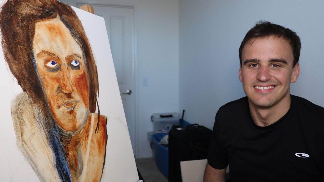 27-year-old Brian Menish, a recovering addict who paints using his left hand. 