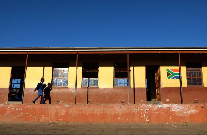 Nearly seven-in-ten South Africans believe education will be better for their children, according to the survey. <br />Pictured here: a student walks to school in the town of Mthatha in the Eastern Cape in June 2013.