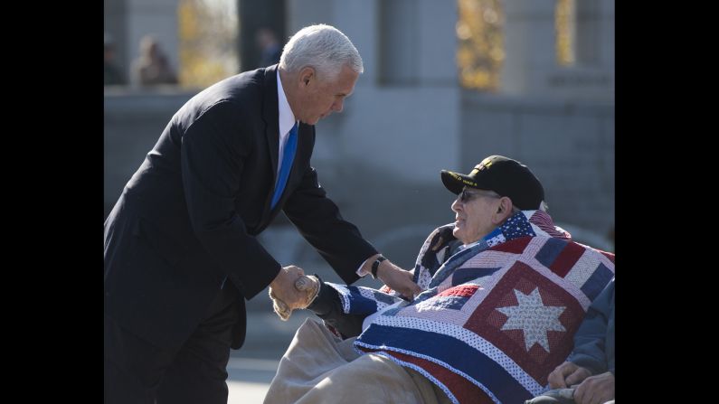 Vice President-elect Mike Pence greets WWII veteran William Flatters during a ceremony at the National World War II Memorial in Washington.