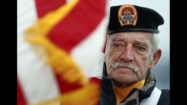 Bill Kiley, a flag bearer of the color guard, participates in a ceremony in Portland, Maine. Kiley served in the Navy from 1954-1958.