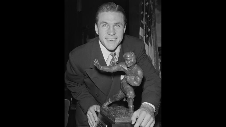 Doak Walker, a halfback for Southern Methodist University, with his Heisman Trophy during a dinner at the Downtown Athletic Club in New York on December 7, 1948. The trophy was established in 1935 and is awarded annually to an "outstanding college football player whose performance best exhibits the pursuit of excellence with integrity," <a href="index.php?page=&url=http%3A%2F%2Fheisman.com%2Fsports%2F2014%2F9%2F15%2FGEN_0915145605.aspx" target="_blank" target="_blank">according to the Heisman Trust</a>.