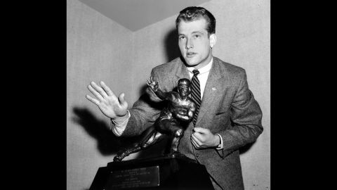 Notre Dame quarterback Paul Hornung imitates the Heisman stance as he poses with his trophy at the Downtown Athletic Club in New York on December 12, 1956. Notre Dame finished 2-8 that year despite Hornung winning the Heisman.