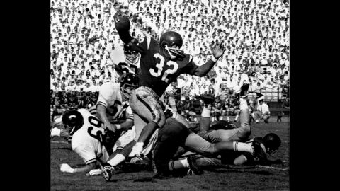 O.J. Simpson, playing for the University of Southern California, tries to break a tackle as he picks up 5 yards in Los Angeles Memorial Coliseum on November 9, 1968. That year, Simpson scored 22 touchdowns.