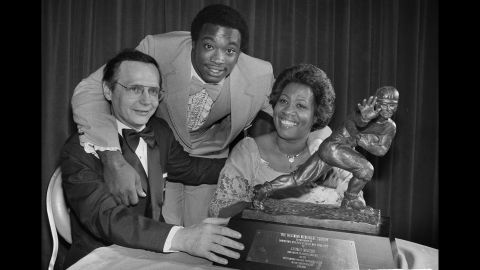 Heisman Trophy winner George Rogers, center, poses with his mother, Grady Rogers, and South Carolina Gov. Richard Riley, after he was formally presented with the trophy at a dinner in New York on December 12, 1980. In accepting the trophy, Rogers paid tribute to his mother and his coaches. "I'm happy for the University and for my teammates, too," Rogers said.