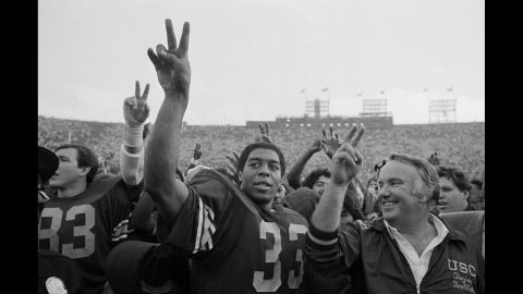 University of Southern California star running back Marcus Allen and coach John Robinson, right, join the rest of the USC Trojans after their victory over the UCLA Bruins in Los Angeles on November 21, 1981. 