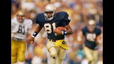 Tim Brown plays in a game at Notre Dame in 1987. Notre Dame and Ohio State are tied with seven Heisman trophy wins, the most any school has won. 