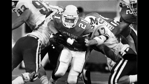 Barry Sanders, playing for Oklahoma State, pushes his way through Miami University-Oxford players during a game in Stillwater, Oklahoma, on September 10, 1988.