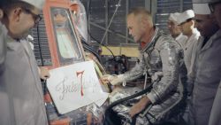 Astronaut John Glenn inspects artwork that will be painted on the outside of his Mercury spacecraft, which he nicknamed Friendship 7. On Feb. 20, 1962, Glenn lifted off into space aboard his Mercury Atlas (MA-6) rocket to become the first American to orbit the Earth. After orbiting the Earth 3 times, Friendship 7 landed in the Atlantic Ocean, just East of Grand Turk Island in the Bahamas. Glenn and his capsule were recovered by the Navy Destroyer Noa, 21 minutes after splashdown.Image Credit: NASA
