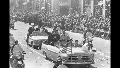 Following his Mercury flight, Glenn and his wife, Annie, join Vice President Lyndon Johnson in the front car of a New York motorcade parade honoring the astronaut. An estimated 4 million people turned out for the March 1, 1962, ticker-tape parade.