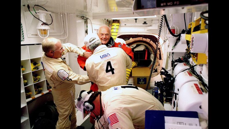 On October 29, 1998, Glenn, then 77, became the <a href="index.php?page=&url=http%3A%2F%2Fwww.cnn.com%2FTECH%2Fspace%2F9811%2F02%2Fshuttle.02%2Findex.html%3Firef%3Dallsearch" target="_blank">oldest person to venture into space.</a> Here, he has his flight suit checked before climbing into the space shuttle Discovery. His second flight into space came 36 years after his legendary Mercury launch.