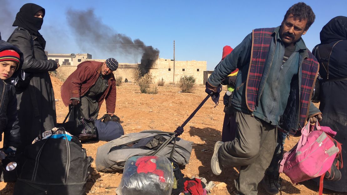 Families looked weary as they followed the path out of eastern Aleppo.