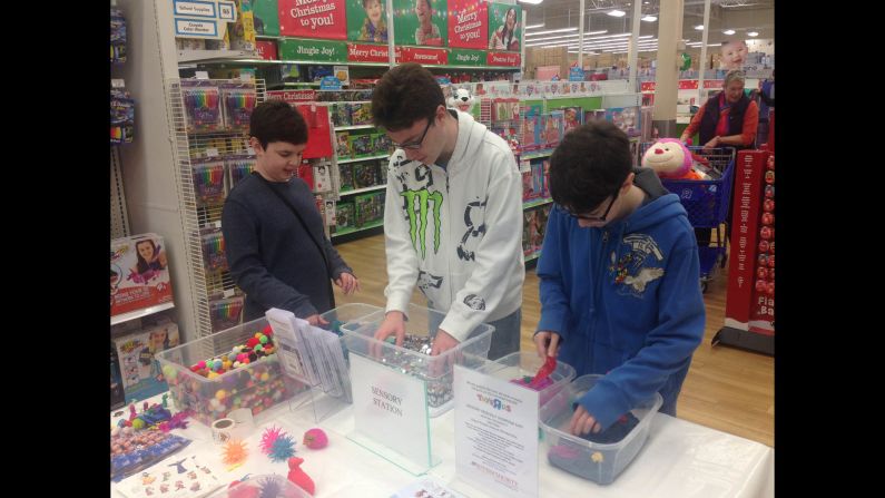 Adam, Billy and Robert Moser play at a sensory station during the Toys "R" Us shopping event in King of Prussia, Pennsylvania, on Saturday. Adam, 10, and Robert, 16, are both on the autism spectrum.