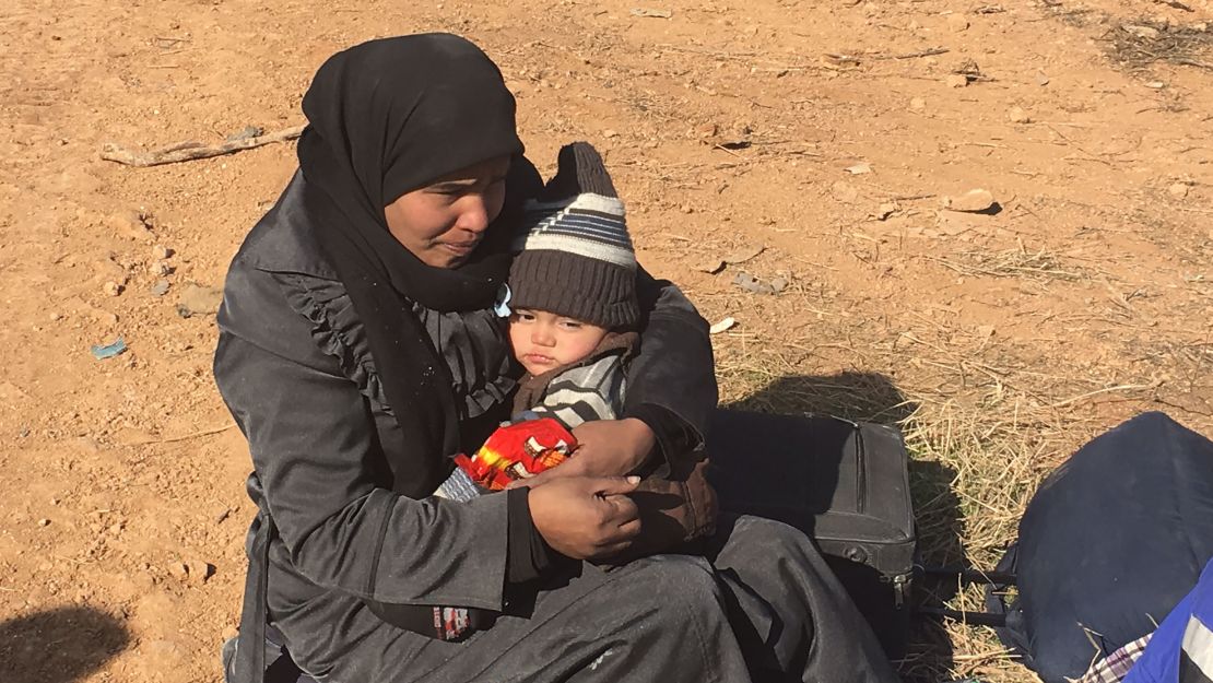 Mothers kept their children close as they made their way into western Aleppo.