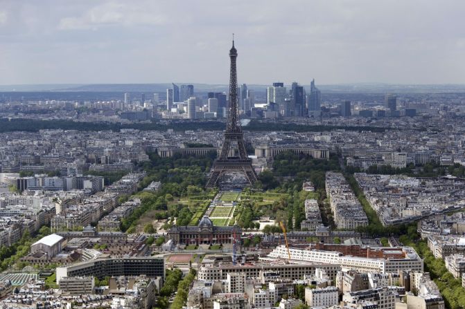 The Eiffel Tower, in Paris, with the business district of La Defense in the background.