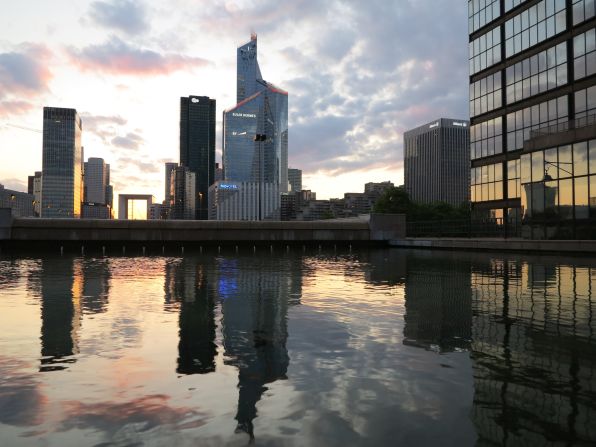 The sunset behind the buildings of La Defense business district in Courbevoie, near Paris.  