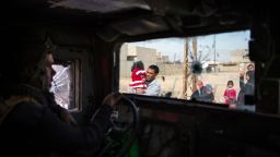 TOPSHOT - People fleeing the fighting are seen from inside an Iraqi Special Forces 2nd division Humvee in Mosul's Arbagiah neighbourhood on November 13, 2016, as they continued to battle Islamic State (IS) group forces pushing through the Arbagiah area and into the neighbourhood of Karkukli.   / AFP / Odd ANDERSEN        (Photo credit should read ODD ANDERSEN/AFP/Getty Images)