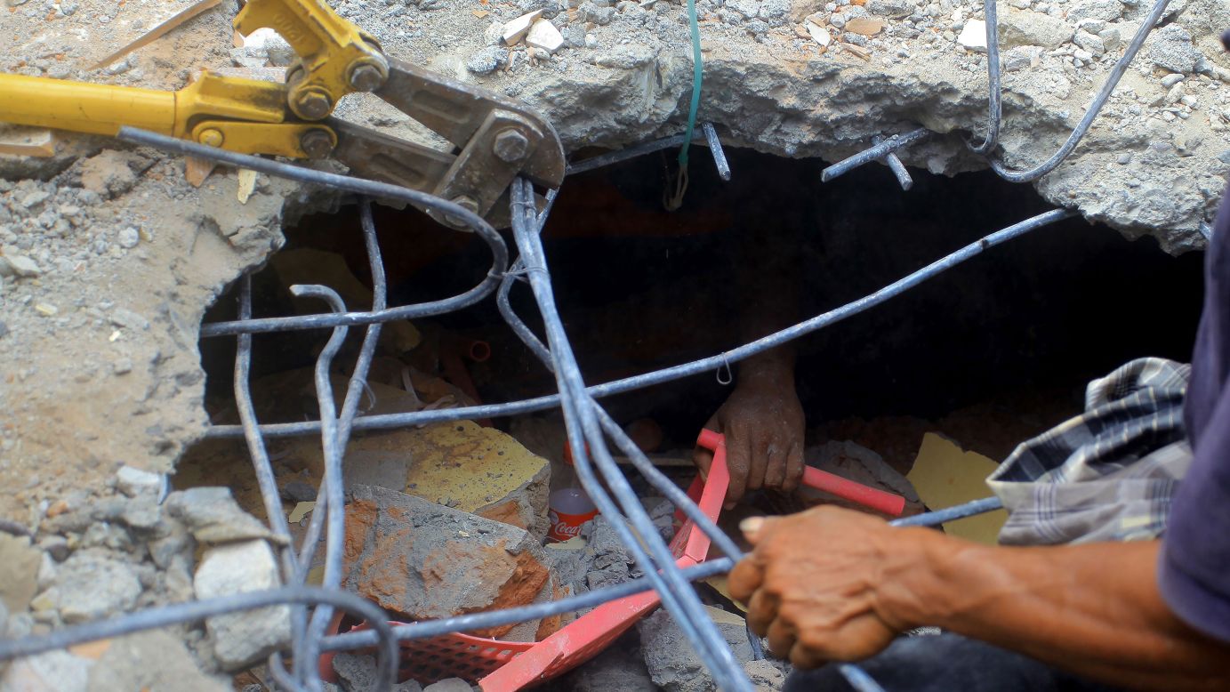 The hand of an earthquake survivor is seen under rubble as residents try to rescue him in the Indonesian province of Aceh on Wednesday, December 7. <a href="http://www.cnn.com/2016/12/06/asia/indonesia-earthquake/" target="_blank">The 6.5-magnitude earthquake</a> struck on Wednesday morning, causing widespread damage, killing at least 102 people and leaving 136 seriously injured, according to Indonesia's Disaster Management and Mitigation Industry. 