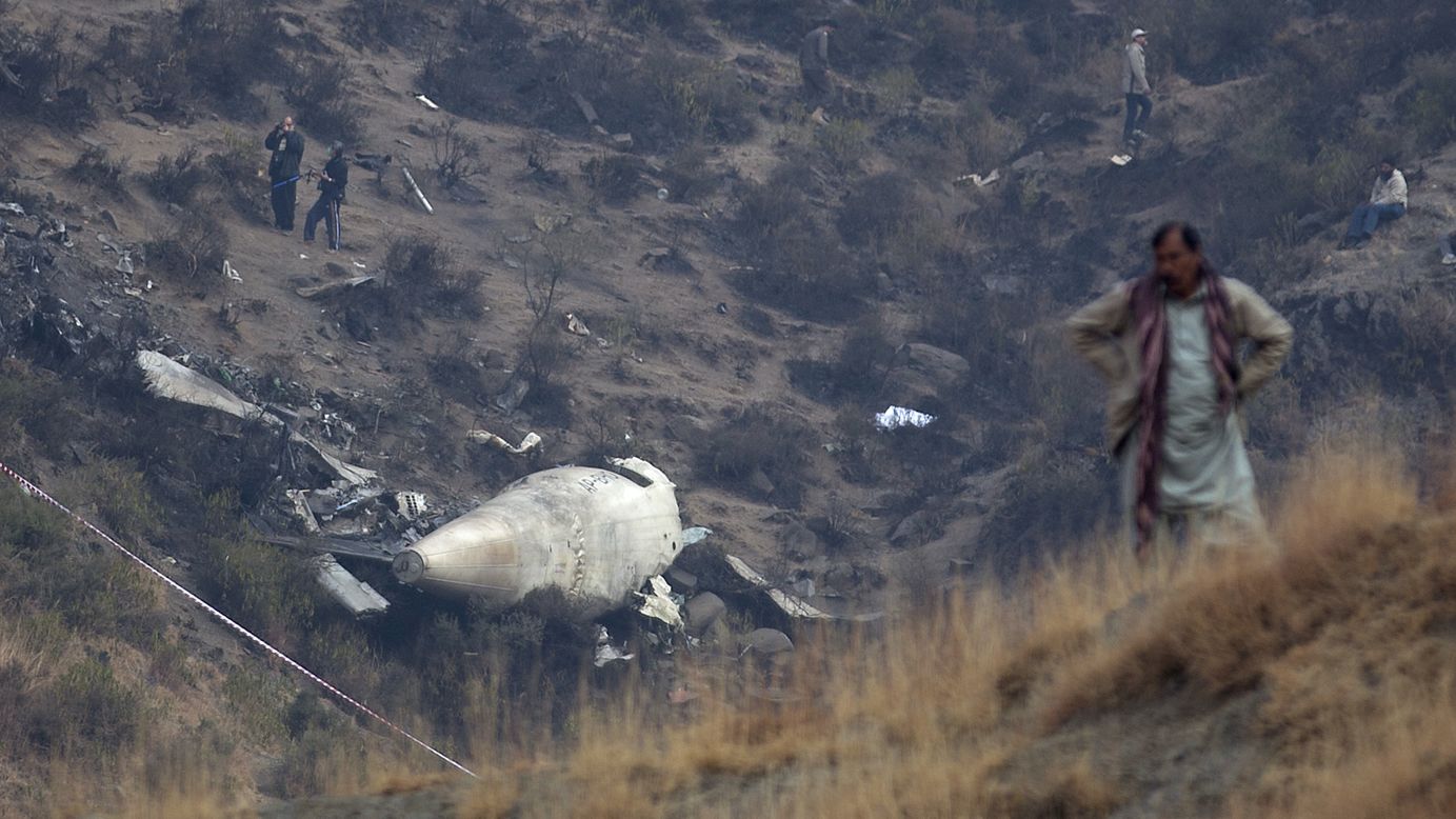 A villager stands near the site of a plane crash as investigators inspect the scene in the village of Gug, Pakistan, on Thursday, December 8. A Pakistan International Airlines flight <a href="http://www.cnn.com/2016/12/07/asia/pakistan-missing-plane/index.html" target="_blank">crashed into the mountains</a> near Abbottabad and Havelian, killing all 47 people on board.