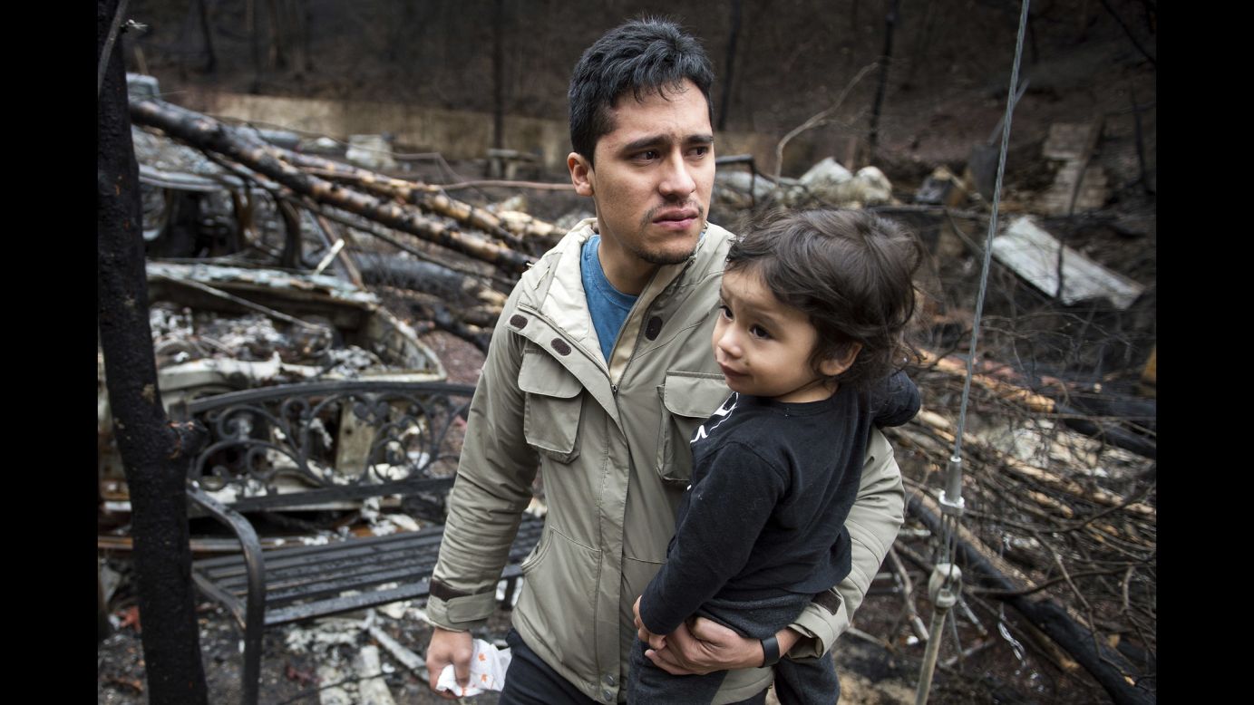 Allan Rivera holds his son, Nathan Rivera, as he looks at the remains of their home in Gatlinburg, Tennessee, on Monday, December 5. A Tennessee wildfire began on November 27 and spread to 17,000 acres -- including the mountain resort of Gatlinburg -- killing 14 people and injuring 175. <a href="http://www.cnn.com/2016/12/07/us/gatlingburg-fire-charges/index.html" target="_blank">Two juveniles are facing charges of aggravated arson</a> in connection with the wildfire, according to authorities. <a href="http://www.cnn.com/2016/12/02/us/gatlinburg-fire-pictures-before-after/index.html" target="_blank">Gatlinburg before and after the fire</a>