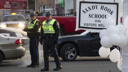 Police stand guard at the entrance to the Sandy Hook School on December 15, 2012 in Newtown, Connecticut. The residents of an idyllic Connecticut town were reeling in horror from the massacre of 20 small children and six adults in one of the worst school shootings in US history. The heavily armed gunman shot dead 18 children inside Sandy Hook Elementary School, said Connecticut State Police spokesman Lieutenant Paul Vance. Two more died of their wounds in hospital.     AFP PHOTO/DON EMMERT        (Photo credit should read DON EMMERT/AFP/Getty Images)