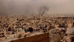 TOPSHOT - A general view taken from Aleppo's citadel show fumes rising following shelling on neighbourhoods in the old city on December 7, 2016. / AFP / GEORGE OURFALIAN        (Photo credit should read GEORGE OURFALIAN/AFP/Getty Images)